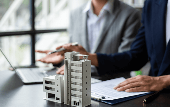 Building models on a desk during a property meeting